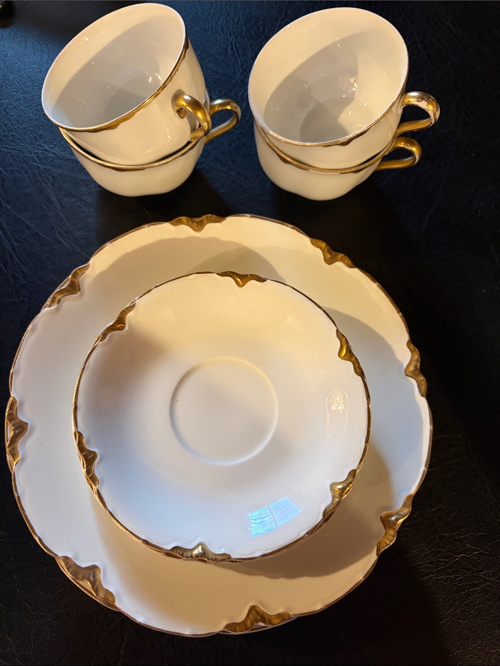 4 Plates, coffee cups and saucers.  From England.